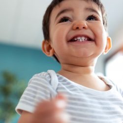 happy-baby-smiling-while-having-fun-at-home-ZFSZR9Z.jpg